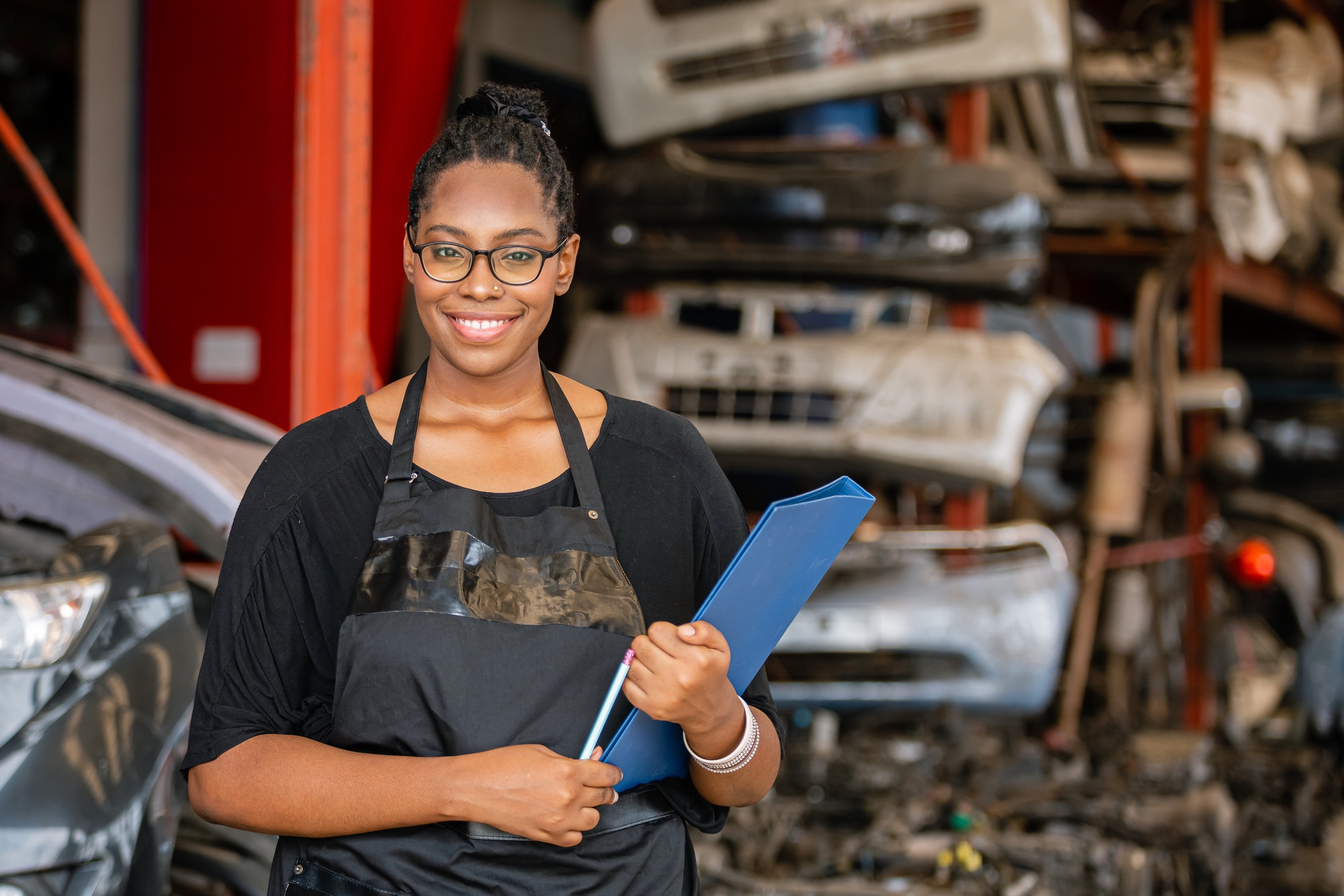 African american worker woman wear spectacles crossed arms holding clipboard standing.