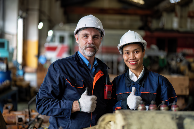 Two workers giving thumbs up.