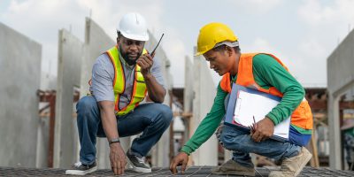 Foreman and laborer check steel reinforcement cage for make precast wall in construction site. Foreman and laborer check steel reinforcement cage for make precast wall in construction site.