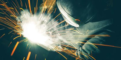 Welder is Welding Two Metal Parts Together Welder is Welding Two Metal Parts Together