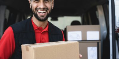 Young delivery man carrying cardboard box – People working with fast deliver transportation Young delivery man carrying cardboard box - People working with fast deliver transportation